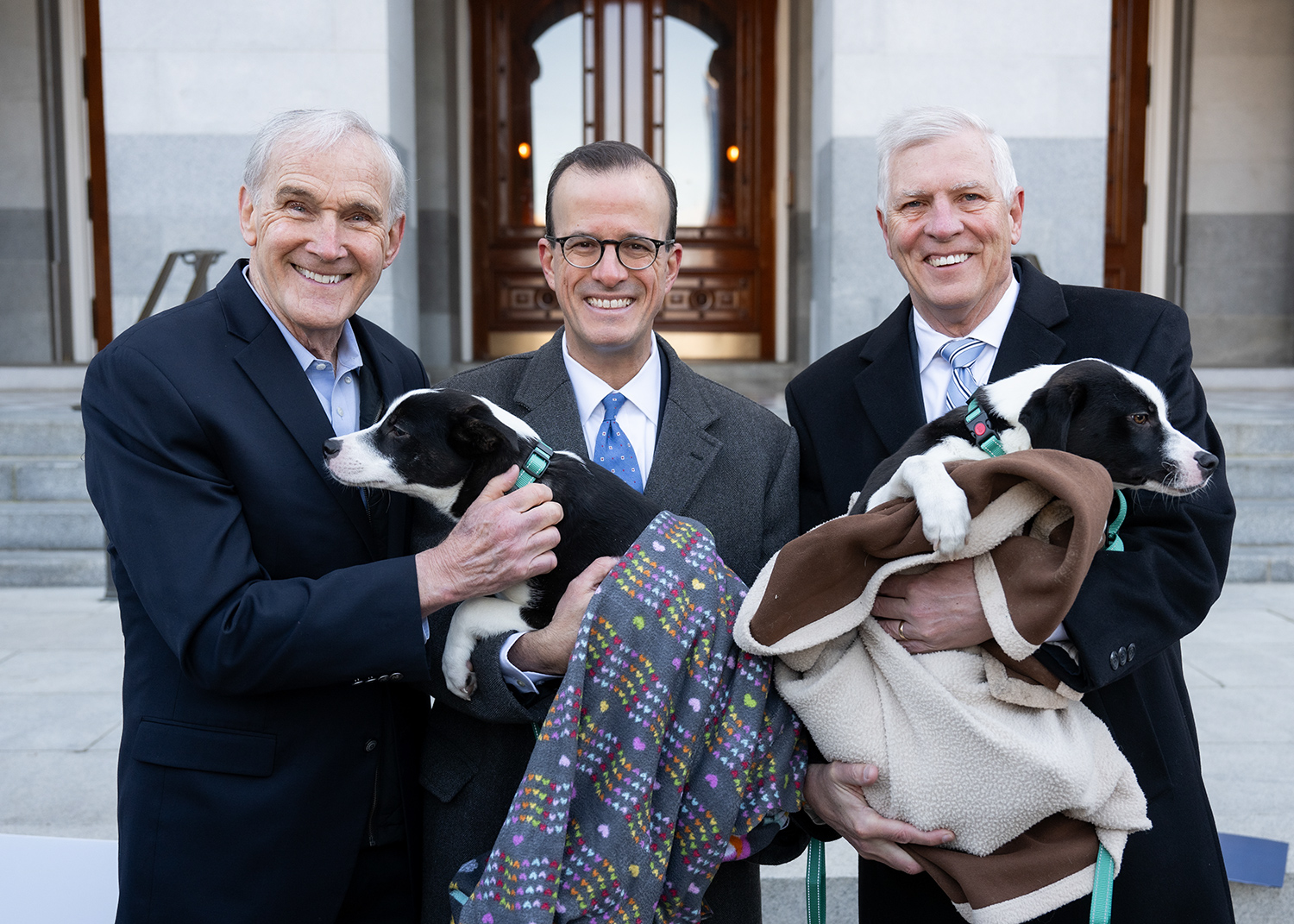 Figure 1 - Assemblymember Bennett (left), Assembymember Berman (middle), and Senator Umberg (right) holding rescue dogs