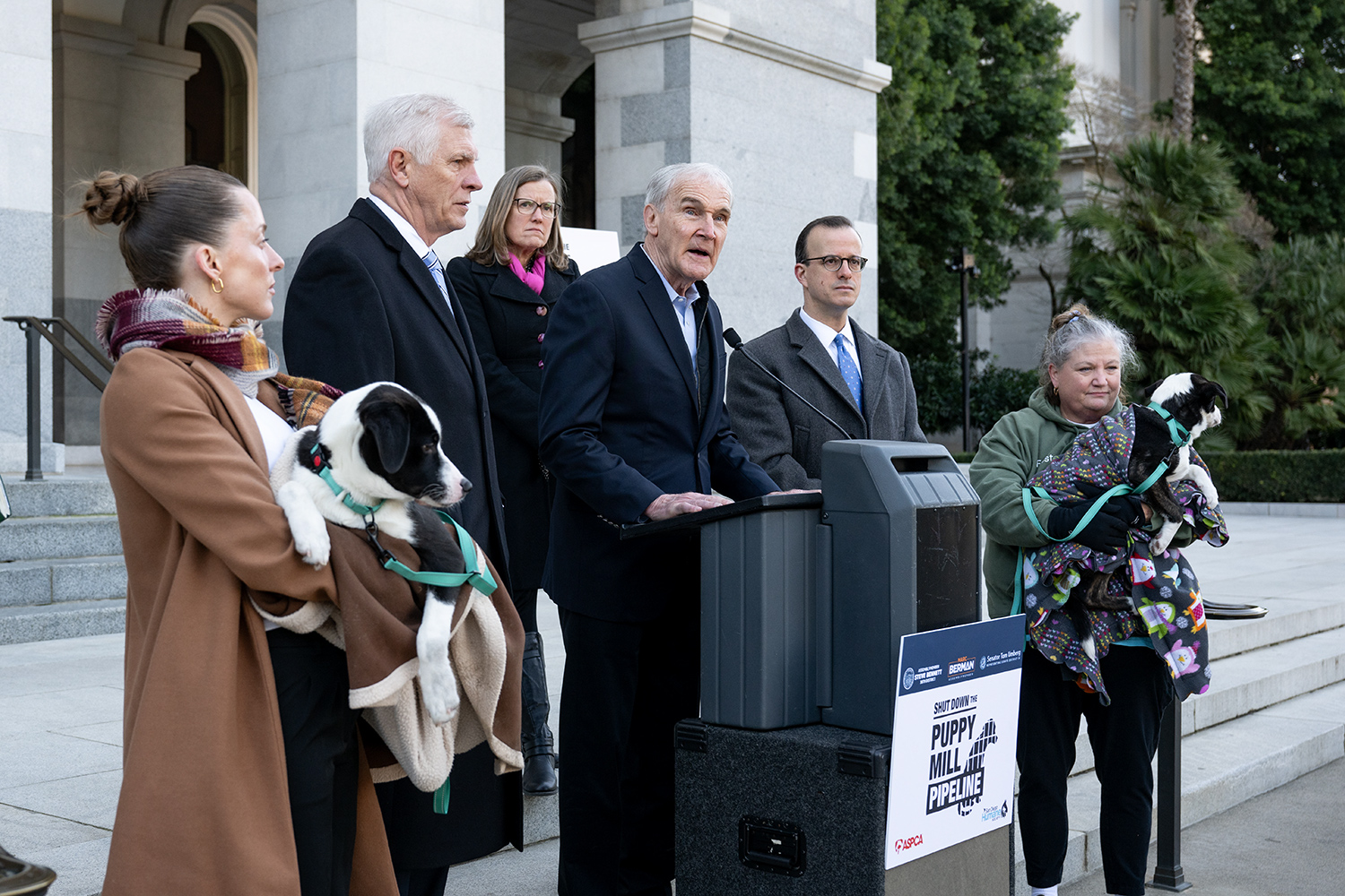 Figure 3 - Assemblymember Bennett speaking at podium with puppy mill stakeholders.