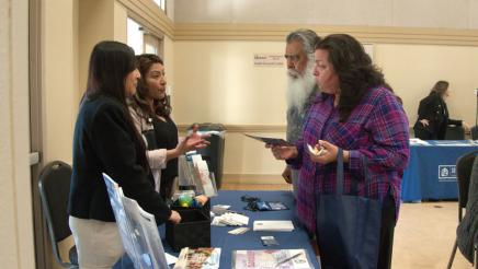 Constituents speaking with staffers and receiving informational flyer
