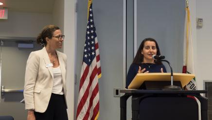 Nicki Parr (left) of Women's Economic Ventures watching Sen. Limón (right) speak