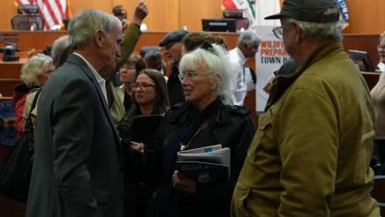 An attendee speaks with Asm. Bennett after Town Hall 