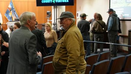 An attendee speaks with Asm. Bennett after Town Hall 