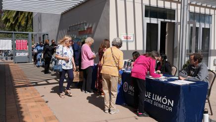 Attendees line up to register.