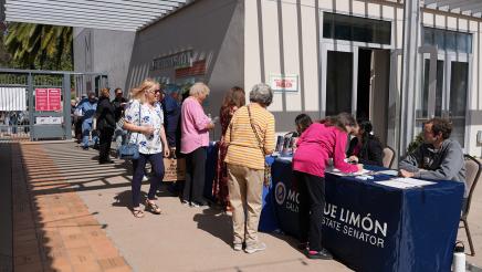 Attendees line up to register.