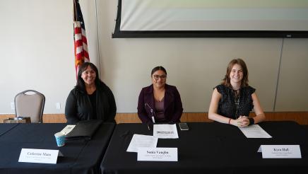 Guest speakers seated at their panelist table.