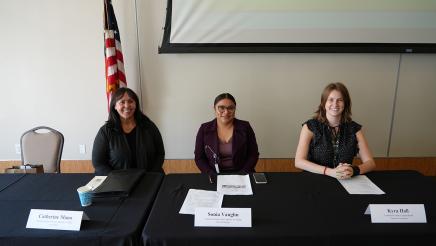 Guest speakers seated at their panelist table.