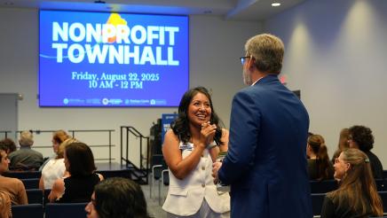 Susy Lopez, Executive Director of Community Action Ventura County, speaks with an attendee.