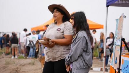 Marianne Parra (left) and daughter Robyn (right) listen to speakers after providing Chumash welcome ceremony.